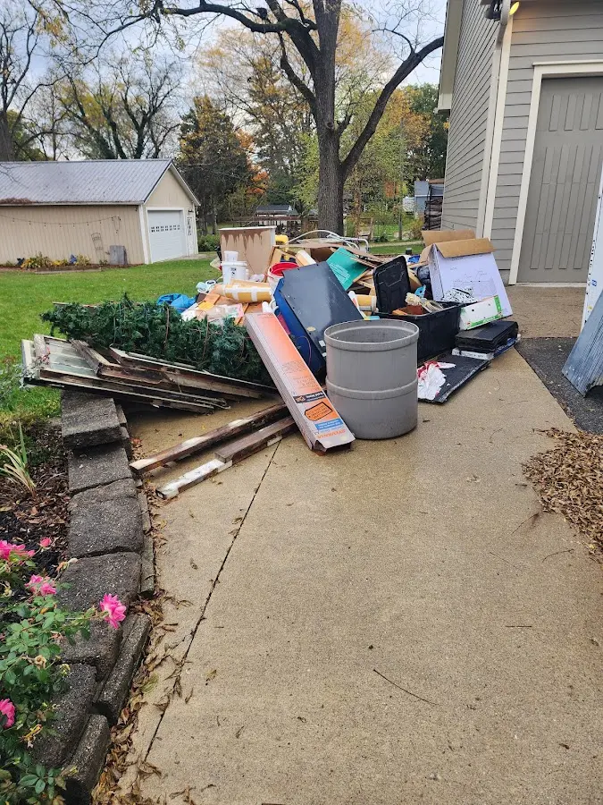 Dumpster being loaded with debris for 12 Yard Dumpster Rental in Orchard Mesa